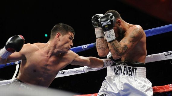 Dmitry Bivol, left, lands a punch Friday night as he stopped Samuel Clarkson to defend his interim light heavyweight title.