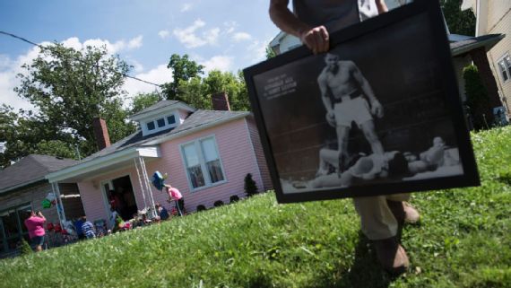 Muhammad Ali's childhood home, pictured in the background here, has drawn more than 10,000 visitors since opening as a museum last year in Louisville