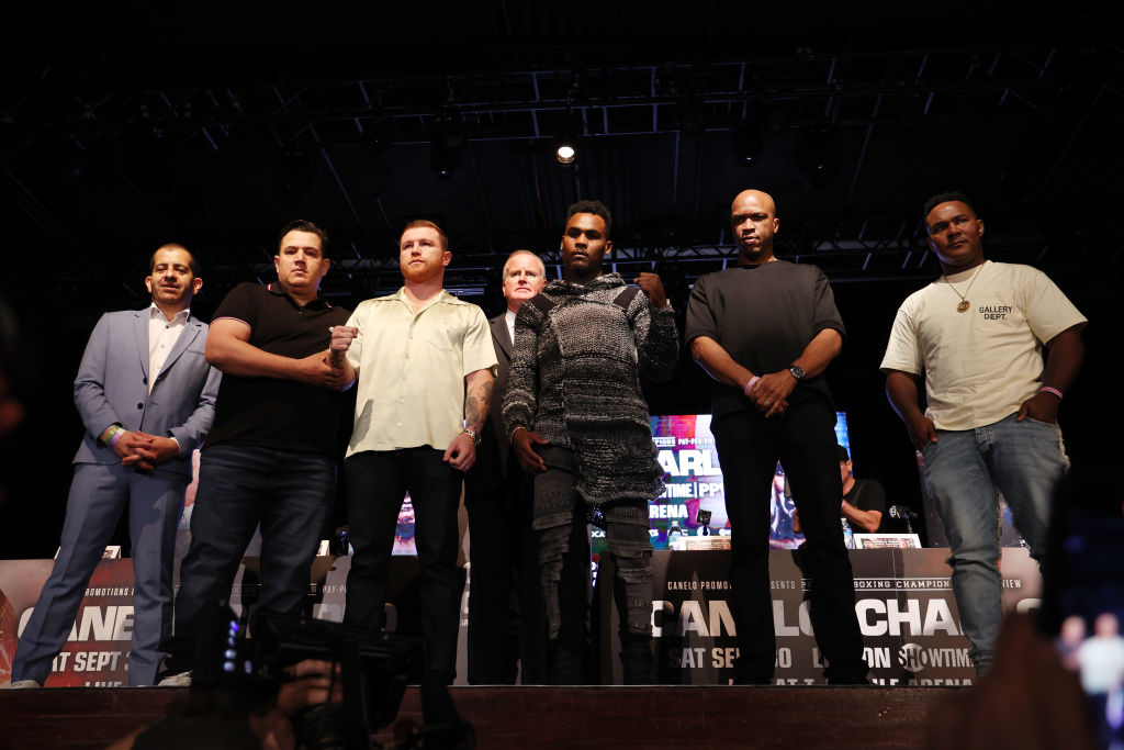 Saul Alvarez and Jermell Charlo with their teams at a press conference. Getty Images