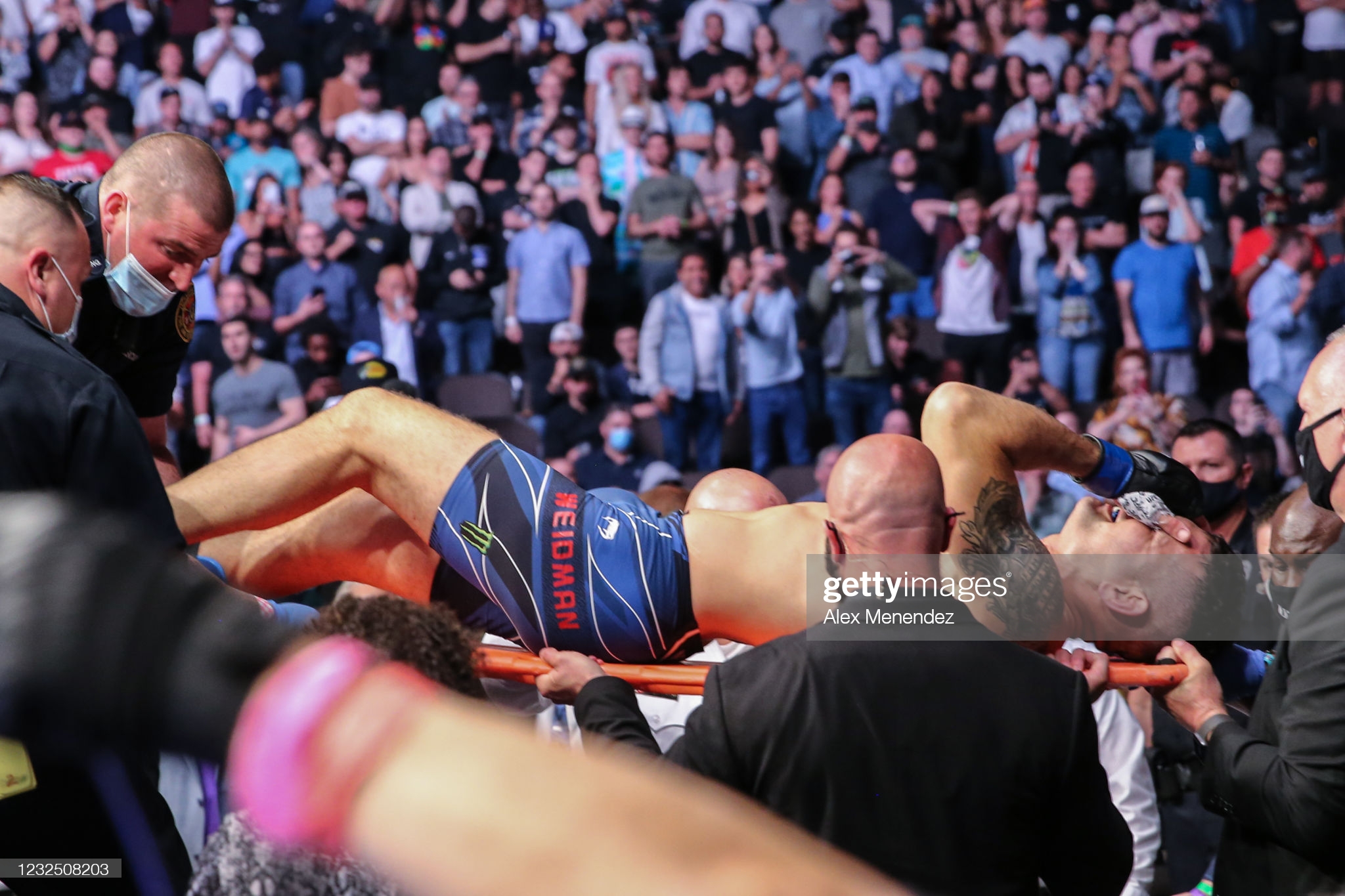 Chris Weidman leaves the Octagon on a stretcher after breaking his leg